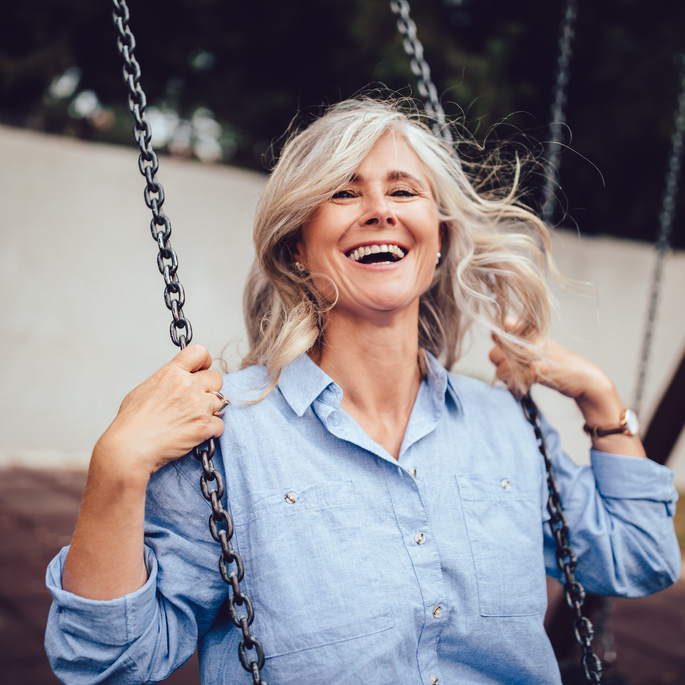 senior woman smiling while swinging